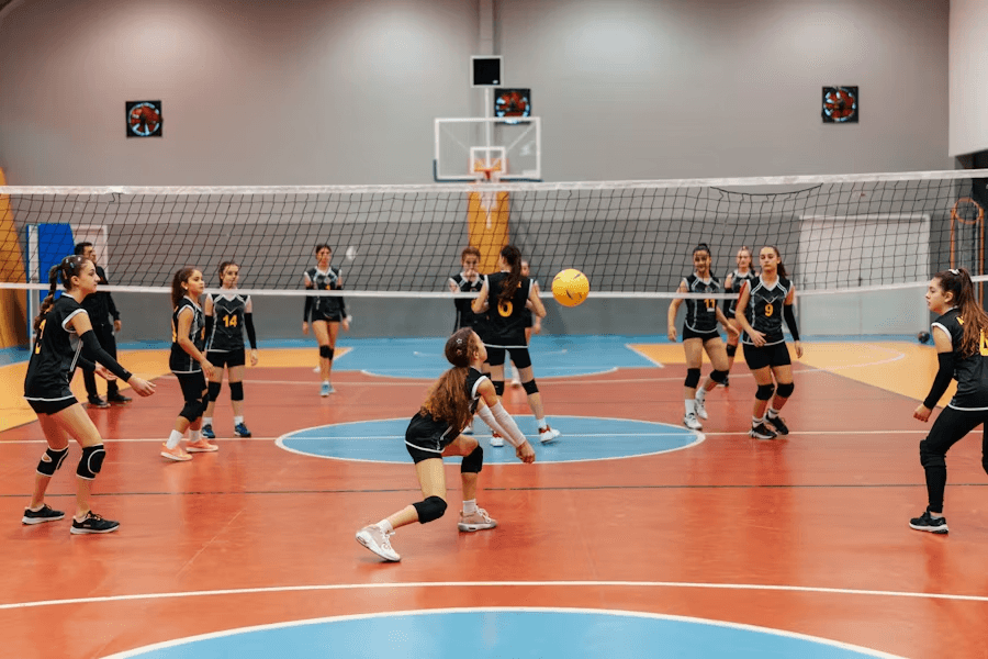 Girls volleyball match on an indoor court